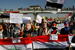 University students hold banners as they gather during ongoing anti-government protests in Baghdad, Iraq, Feb. 6, 2020