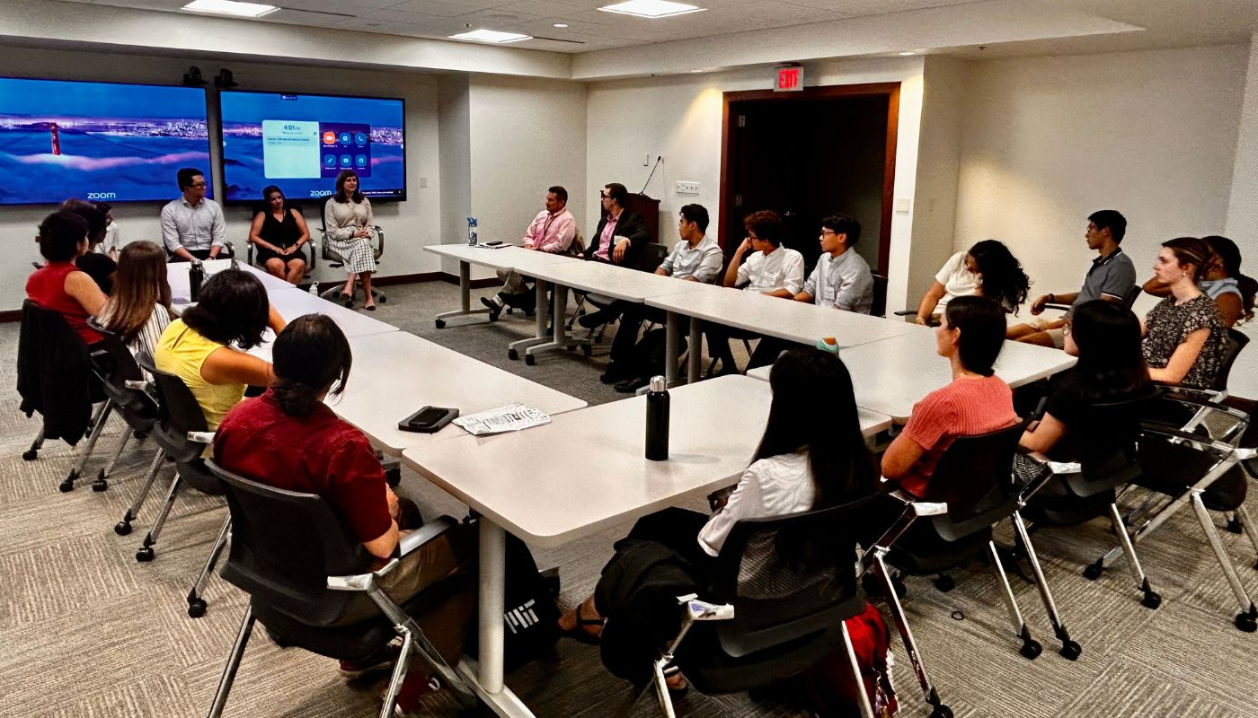 Image of a conference table with a presentation in process