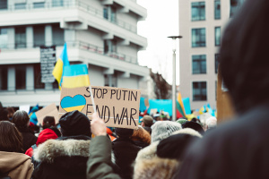 rally with sign reading stop putin end war