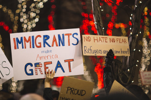 sign reading Immigrants are great seen at rally