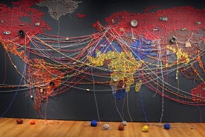 Flattened world map on wall created with yarn